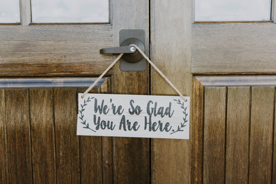 wedding sign welcoming guests on wooden doors