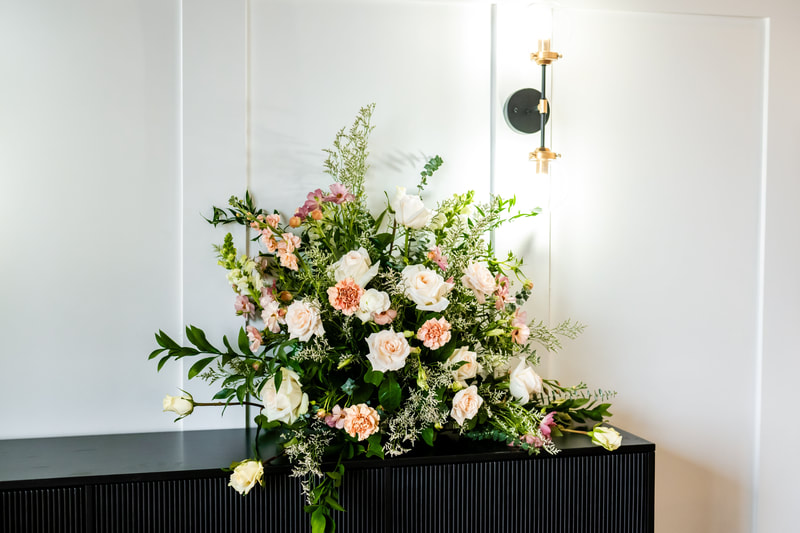 DFW venue with elegant entry, white walls and black modern accents