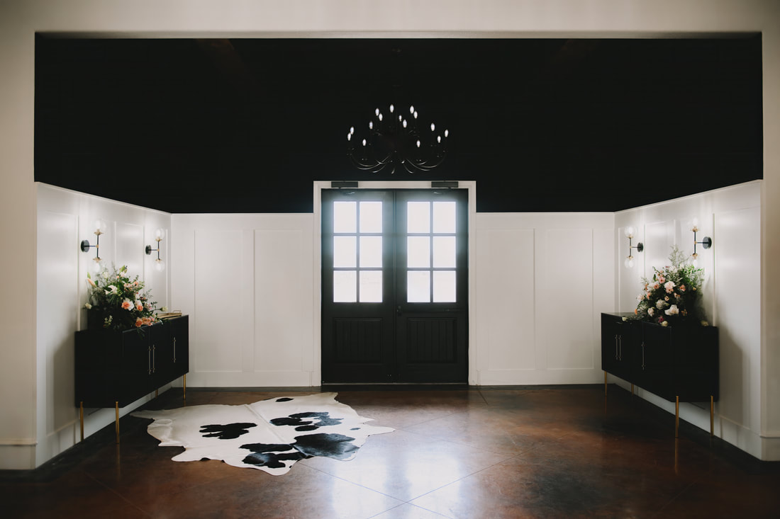 DFW Wedding Venue - modern entry with black and white elegant features, cowhide and chandelier