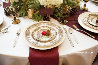 warm winter wedding style, burgundy napkins, chocolates and pinecones
