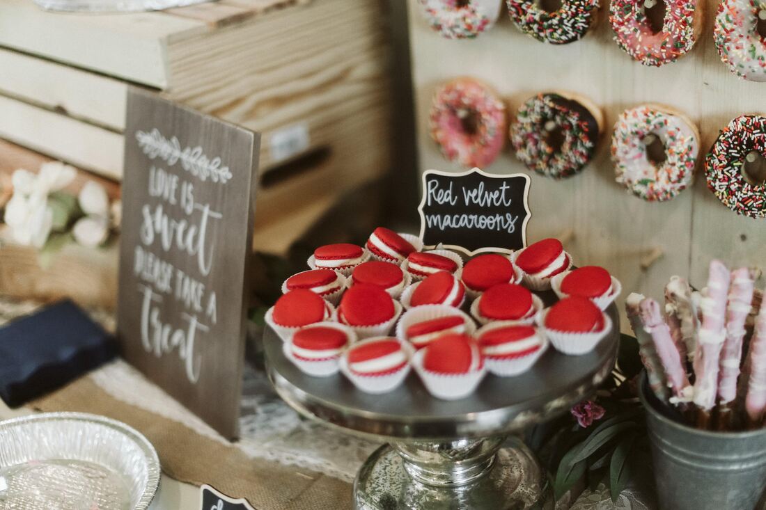 dessert table with macaroons, cookies, cupcakes and more holiday party hosting