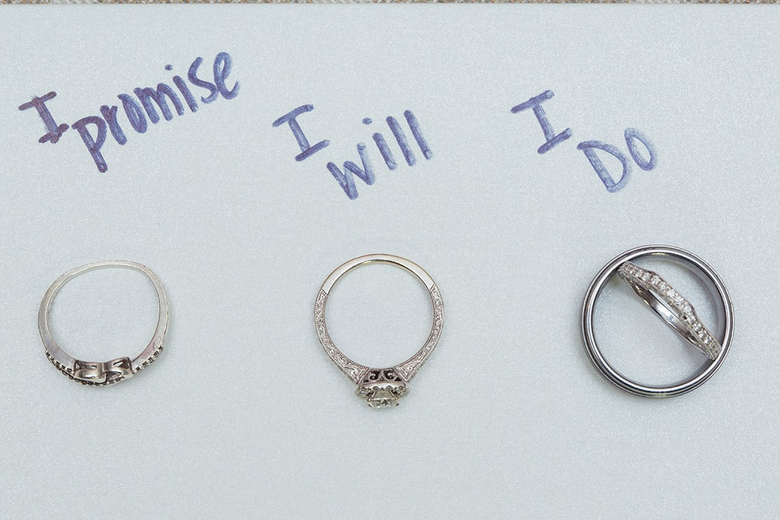 promise ring, engagement ring and wedding bands all next to each other
