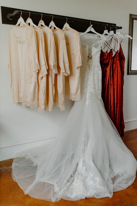 bridal gown and robes hanging in dressing room