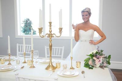 bride at reception venue, toasting with elegant stemware, gold accents and large windows