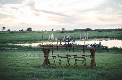 outdoor farm table decor, wedding inspiration and candles for romantic setting near water