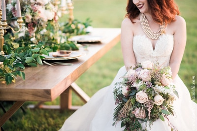 boho whimsical wedding inspiration, outdoor dinner with bride and wooden farm table